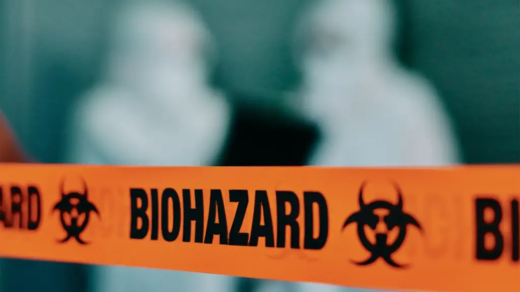 Yellow biohazard tape with black symbols stretches across a scene, emphasizing caution and safety in hazardous areas.