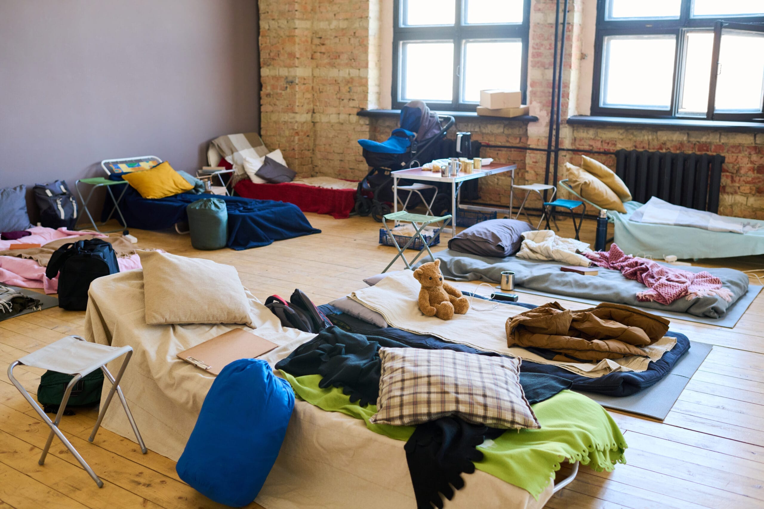 tear gas cleanup Dallas - Spacious room with numerous sleeping places, blankets, pillows, and toys prepared for refugees